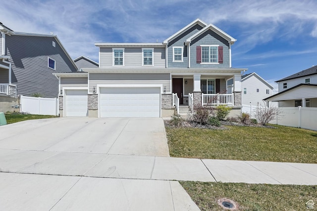 728 W Wild Hyacinth Dr, Saratoga Springs, UT 84045 - craftsman-style house featuring a porch, fence, a front lawn, concrete driveway, and stone siding