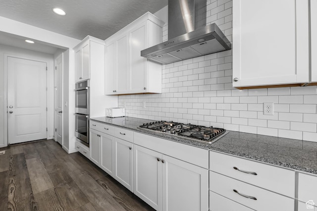 728 W Wild Hyacinth Dr, Saratoga Springs, UT 84045 - kitchen featuring dark wood finished floors, white cabinets, dark stone countertops, stainless steel appliances, and wall chimney exhaust hood