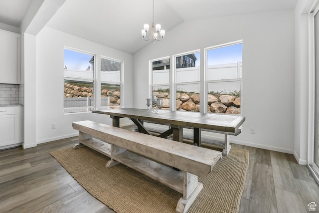 728 W Wild Hyacinth Dr, Saratoga Springs, UT 84045 - dining room featuring a wealth of natural light, vaulted ceiling, light wood finished floors, and a chandelier