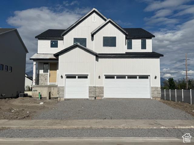 166 N Husker Ln Unit 1, Saratoga Springs, UT 84045 - modern inspired farmhouse with stone siding, gravel driveway, and an attached garage