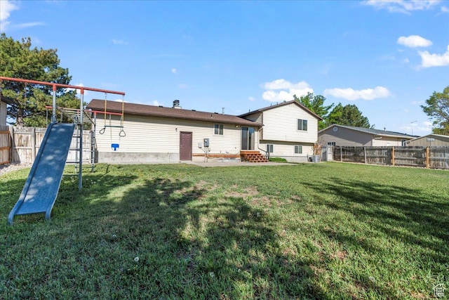 12455 S 1450 W, Riverton, UT 84065 - back of house featuring a fenced backyard, entry steps, and a lawn