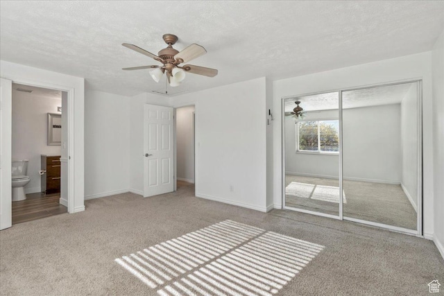 12455 S 1450 W, Riverton, UT 84065 - unfurnished bedroom with carpet floors, connected bathroom, a textured ceiling, and a closet