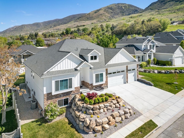 735 E 850 S, Centerville, UT 84014 - view of front of property featuring stone siding, a garage, board and batten siding, driveway, and a mountain view