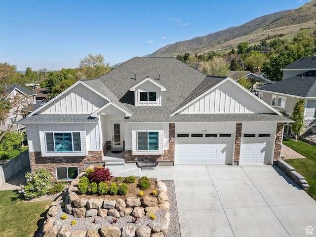 735 E 850 S, Centerville, UT 84014 - view of front of house featuring stone siding, roof with shingles, board and batten siding, a garage, and concrete driveway