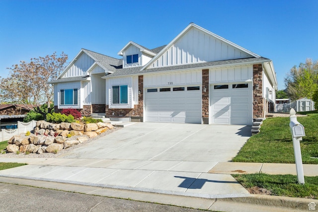735 E 850 S, Centerville, UT 84014 - view of front of home with stone siding, board and batten siding, an attached garage, concrete driveway, and roof with shingles