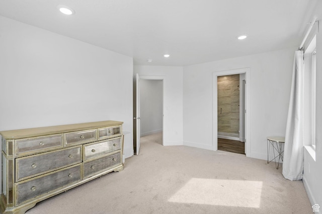 bedroom featuring baseboards, recessed lighting, connected bathroom, and light carpet