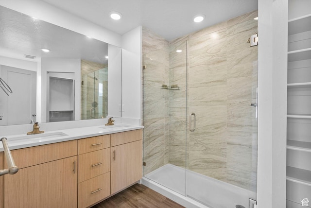 full bath with a sink, a stall shower, and visible vents
