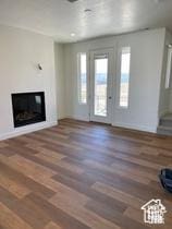 10983 S Lake Run Rd, South Jordan, UT 84009 - unfurnished living room with a glass covered fireplace and wood finished floors