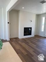 10983 S Lake Run Rd, South Jordan, UT 84009 - unfurnished living room with a glass covered fireplace, wood finished floors, recessed lighting, and baseboards