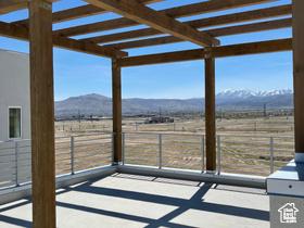 10983 S Lake Run Rd, South Jordan, UT 84009 - unfurnished sunroom with a mountain view and a view of countryside