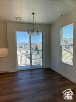 10983 S Lake Run Rd, South Jordan, UT 84009 - unfurnished dining area with a chandelier, wood finished floors, and baseboards