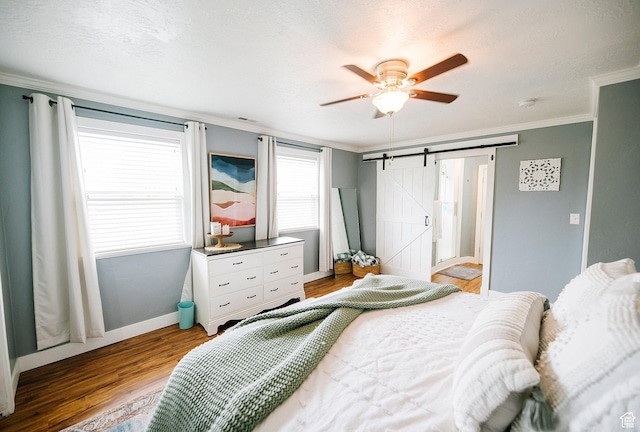663 W 3500 S, Bountiful, UT 84010 - bedroom with crown molding, a barn door, a ceiling fan, baseboards, and wood finished floors