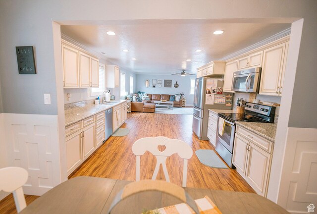 663 W 3500 S, Bountiful, UT 84010 - kitchen with open floor plan, appliances with stainless steel finishes, cream cabinetry, and light wood-style flooring