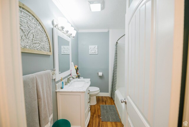 663 W 3500 S, Bountiful, UT 84010 - bathroom featuring wood finished floors, vanity, toilet, ornamental molding, and shower / bath combo with shower curtain
