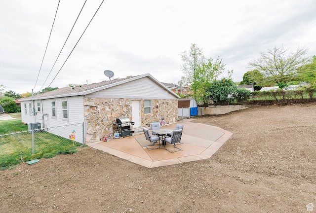 663 W 3500 S, Bountiful, UT 84010 - back of property featuring fence, central AC, stone siding, a shed, and a patio area