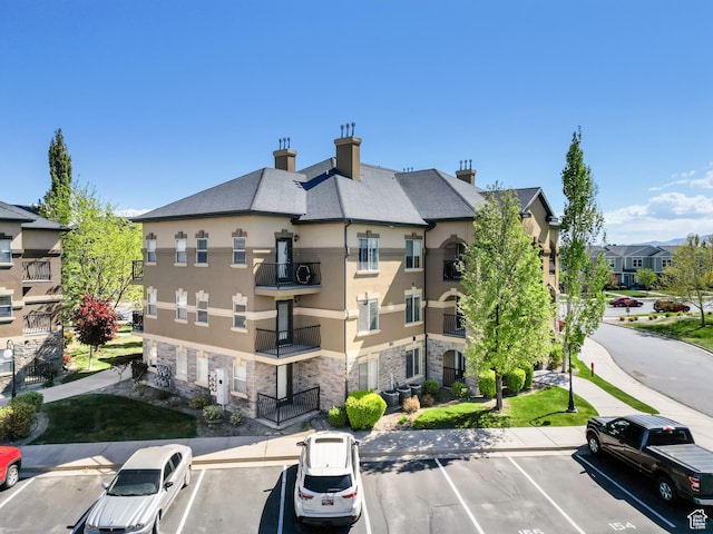 425 S 2220 W Unit 202, Pleasant Grove, UT 84062 - view of property featuring central air condition unit, a residential view, and uncovered parking