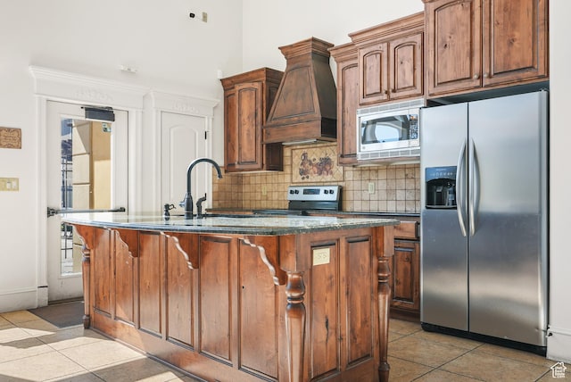 425 S 2220 W Unit 202, Pleasant Grove, UT 84062 - kitchen with decorative backsplash, custom exhaust hood, light tile patterned flooring, an island with sink, and stainless steel appliances