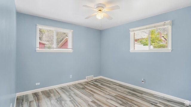940 S Taylor E, Ogden, UT 84404 - empty room featuring visible vents, a ceiling fan, wood finished floors, and a healthy amount of sunlight