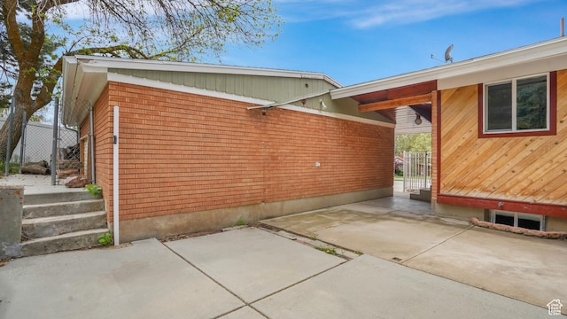 940 S Taylor E, Ogden, UT 84404 - view of property exterior featuring brick siding and a patio area