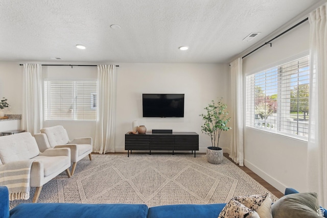 4236 N Magnolia Cir, Eagle Mountain, UT 84005 - living area with baseboards, recessed lighting, a textured ceiling, and visible vents
