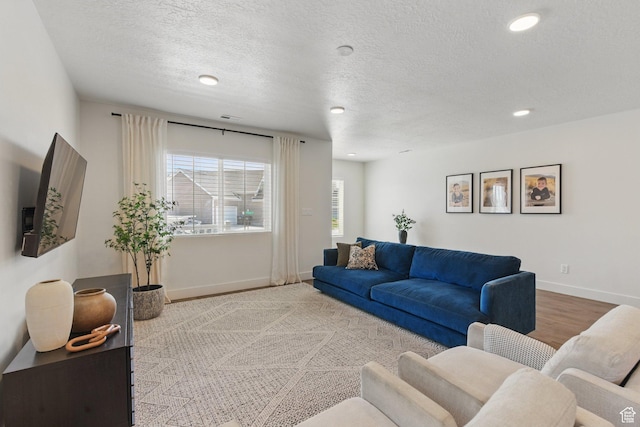 4236 N Magnolia Cir, Eagle Mountain, UT 84005 - living room featuring recessed lighting, baseboards, wood finished floors, and a textured ceiling