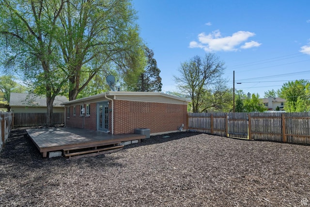 931 E 7800 S, Midvale, UT 84047 - exterior space with central AC, brick siding, a wooden deck, a fenced backyard, and french doors