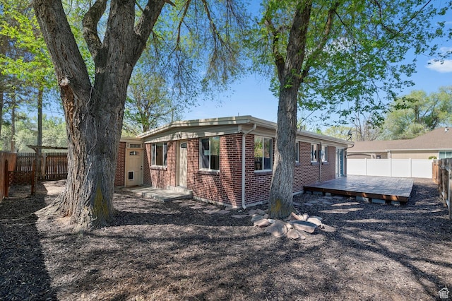 931 E 7800 S, Midvale, UT 84047 - exterior space featuring brick siding, a fenced backyard, and a deck