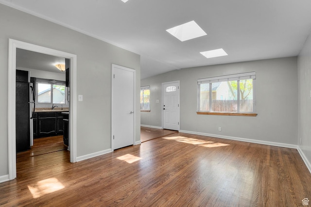 931 E 7800 S, Midvale, UT 84047 - interior space with baseboards, lofted ceiling with skylight, and wood finished floors