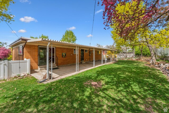 3475 S 3650 E, Millcreek, UT 84109 - rear view of house with brick siding, a fenced backyard, and a yard