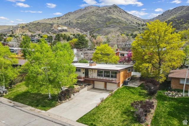 3475 S 3650 E, Millcreek, UT 84109 - view of front of property with concrete driveway, an attached garage, a mountain view, and a front lawn