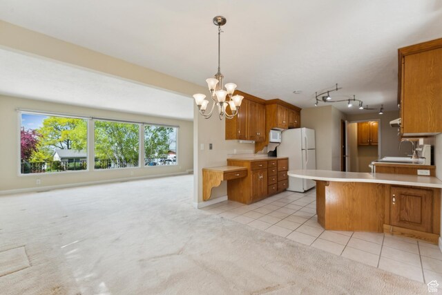 3475 S 3650 E, Millcreek, UT 84109 - kitchen featuring a sink, light countertops, freestanding refrigerator, and brown cabinets