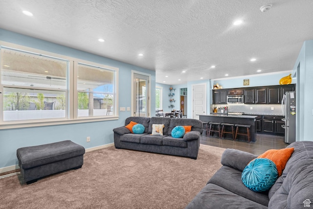 145 W 750 S, American Fork, UT 84003 - living area featuring a textured ceiling, baseboards, recessed lighting, and dark colored carpet