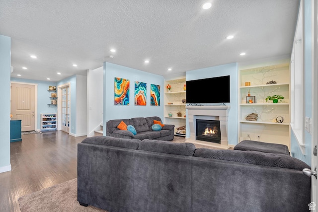 145 W 750 S, American Fork, UT 84003 - living room featuring a textured ceiling, a glass covered fireplace, recessed lighting, baseboards, and dark wood-style floors
