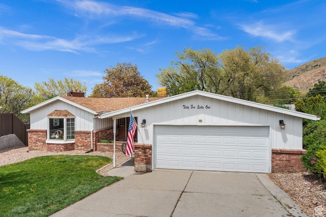 3581 E Yosemite Dr S, Millcreek, UT 84109 - ranch-style house featuring brick siding, a chimney, concrete driveway, and a garage