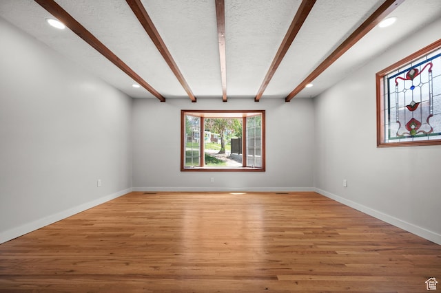 3581 E Yosemite Dr S, Millcreek, UT 84109 - unfurnished room with beamed ceiling, recessed lighting, light wood-type flooring, baseboards, and a textured ceiling