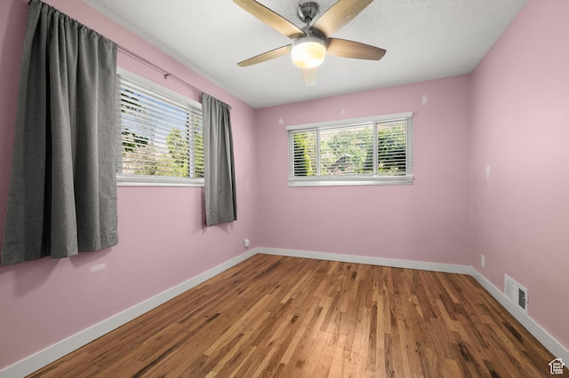 3581 E Yosemite Dr S, Millcreek, UT 84109 - spare room featuring healthy amount of natural light, wood finished floors, baseboards, and a ceiling fan
