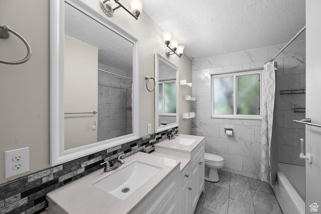3581 E Yosemite Dr S, Millcreek, UT 84109 - full bath featuring marble look tile flooring, a textured ceiling, tile walls, toilet, and double vanity