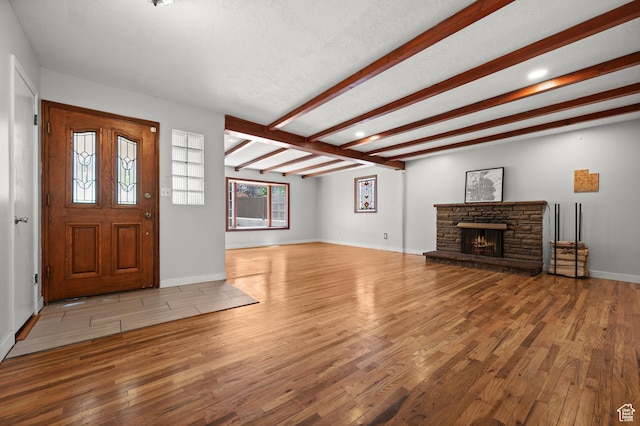 3581 E Yosemite Dr S, Millcreek, UT 84109 - foyer featuring wood finished floors, a fireplace, beam ceiling, and baseboards