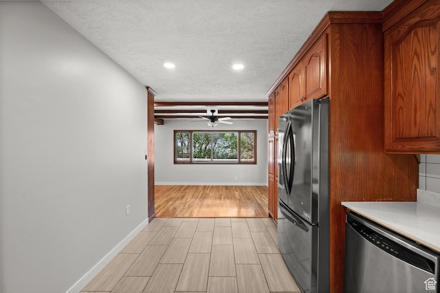 3581 E Yosemite Dr S, Millcreek, UT 84109 - kitchen featuring freestanding refrigerator, stainless steel dishwasher, a textured ceiling, brown cabinets, and light countertops