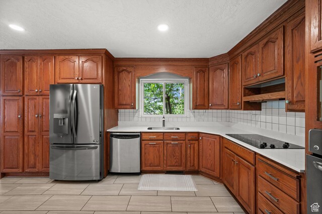 3581 E Yosemite Dr S, Millcreek, UT 84109 - kitchen with appliances with stainless steel finishes, a sink, tasteful backsplash, light countertops, and recessed lighting