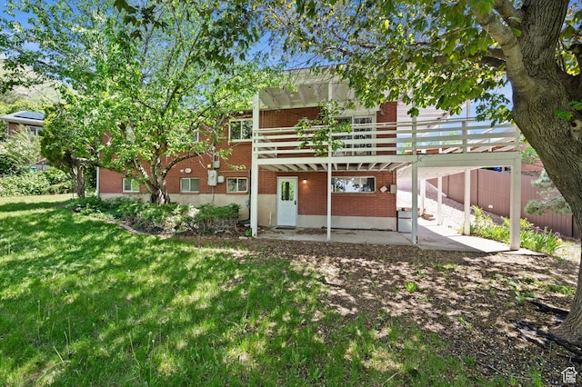 3581 E Yosemite Dr S, Millcreek, UT 84109 - rear view of house with brick siding, a patio, a lawn, and a wooden deck