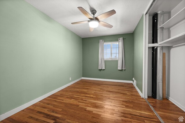 3581 E Yosemite Dr S, Millcreek, UT 84109 - unfurnished bedroom featuring wood finished floors, baseboards, a closet, and a ceiling fan