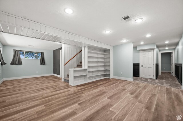 3581 E Yosemite Dr S, Millcreek, UT 84109 - below grade area with baseboards, light wood finished floors, stairs, recessed lighting, and built in features