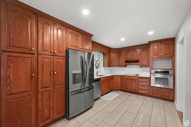 3581 E Yosemite Dr S, Millcreek, UT 84109 - kitchen featuring appliances with stainless steel finishes, tasteful backsplash, light countertops, brown cabinetry, and a sink