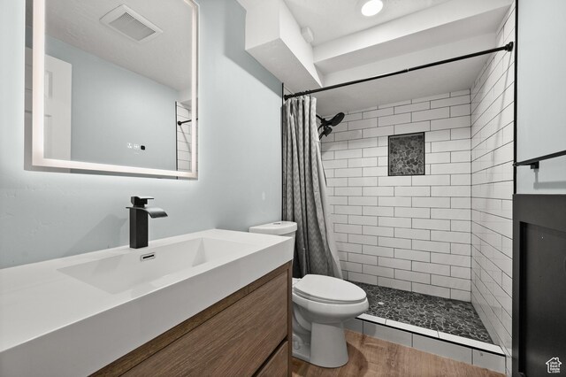 3581 E Yosemite Dr S, Millcreek, UT 84109 - full bathroom with tiled shower, toilet, and vanity