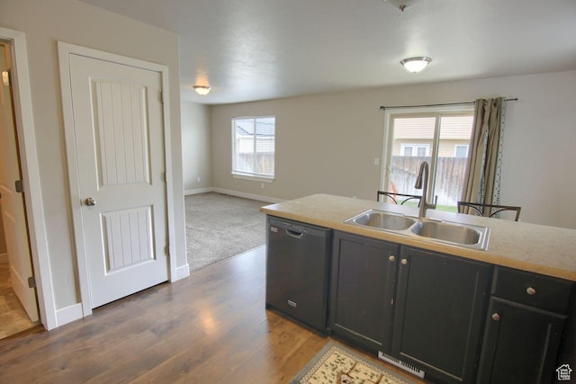 566 N 640 W, Tooele, UT 84074 - kitchen with wood finished floors, dishwasher, a sink, baseboards, and dark cabinetry