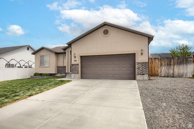 566 N 640 W, Tooele, UT 84074 - single story home featuring brick siding, an attached garage, fence, and stucco siding