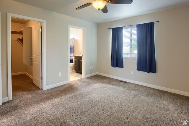 566 N 640 W, Tooele, UT 84074 - unfurnished bedroom with visible vents, baseboards, a spacious closet, carpet flooring, and ensuite bath