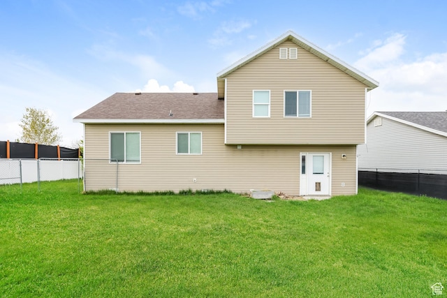 4018 W 5250 S, Roy, UT 84067 - rear view of property with a lawn, a shingled roof, and a fenced backyard
