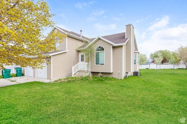4018 W 5250 S, Roy, UT 84067 - view of front of home with fence, a chimney, cooling unit, and a front lawn